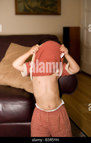 two year old boy playing peek-a-boo with his t-shirt Stock Photo