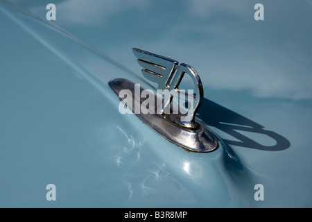 Old defunct logo of the Austin car company mascot casts a shadow over the bonnet Stock Photo