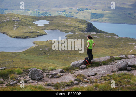 A young girl walking on Beinn Ghobhlach looking across Loch Broom in Wester Ross Scottish Highlands Scotland Stock Photo