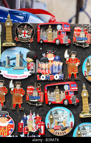 London tourist souvenir stall in Westminster selling badges and fridge magnets of Big Ben London Bus Tower Bridge and Beefeater Stock Photo