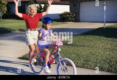 Grandmother and grandkids,teaching cycling, cycling together in park, Miami. Stock Photo