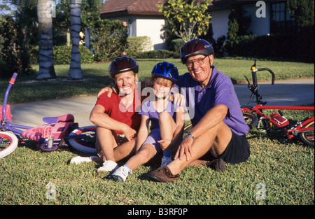 Grandmother and grandkids, cycling together in park, Miami. Stock Photo