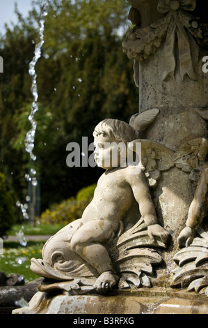 One of the Cherubs adoring the fountain in Cheltenham s Sandford Park Stock Photo