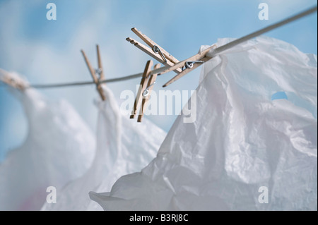 plastic bags hanging on laundry clothes line to dry and be reused Stock Photo