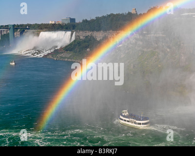Canada,Ontario,Niagara Falls,Maid of the Mist tour boat approaching the American Falls with a rainbow Stock Photo