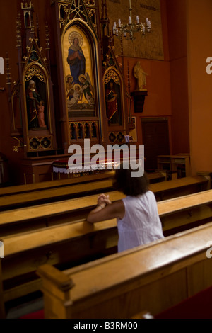 Woman in prayer, Catholic church, Zielona Gora, Poland Stock Photo