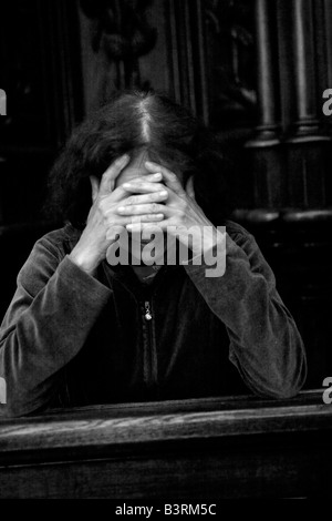 Woman prays in a Catholic Church in Krakow Poland Stock Photo