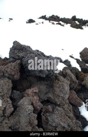 Volcanic rocks in snow Stock Photo