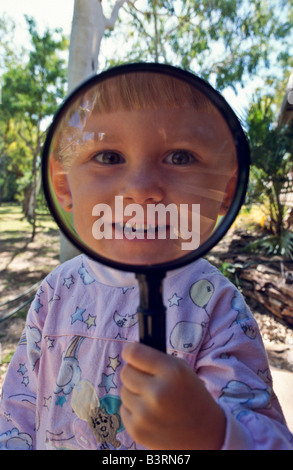 Young girl with magnifying ^glass Stock Photo