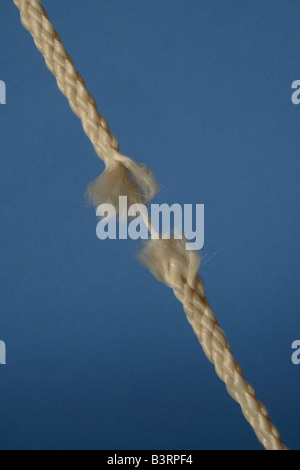 Cut and frayed rope hanging by a thread and ready to break Stock Photo ...