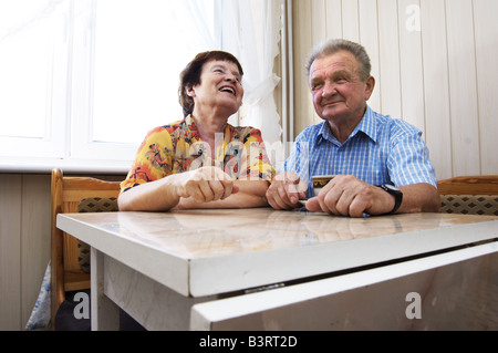 Happy senior couple in kitchen Stock Photo