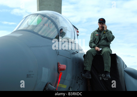 Pilot phoning sitting on the fuselage of fighter plane F-15, Arctic Thunder airshow 2008, Anchorage, Alaska, USA Stock Photo