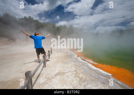 Man at Champagne Pool at geothermal site, Wai-O-Tapu Thermal Wonderland on North Island of New Zealand Stock Photo