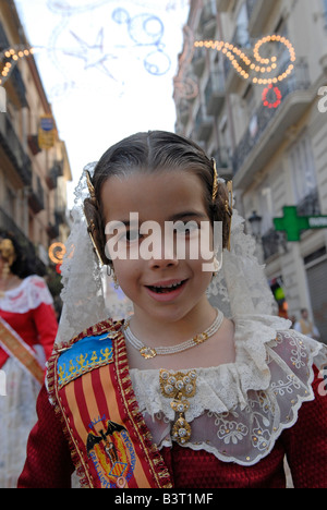 Young girl in traditional Valencian costume in the street during Las Falles traditional festival held in the city of Valencia Spain Stock Photo