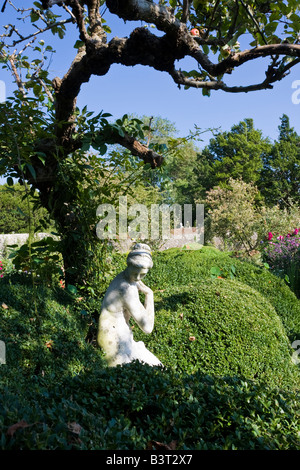 Statue reflecting the shape of the tree shading it, at Charleston Farmhouse, East Sussex Stock Photo