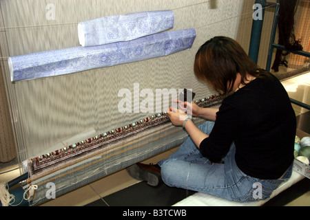 Asia, China, Beijing. Silk Carpet Weaver and loom Stock Photo