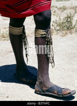 Tanzania, Arusha, Lake Eyasi. A close-up of a Datoga young man's brass and leather leg ornaments. His sandals are made of old tyresThe Datoga (known to their Maasai neighbours as the Mang'ati and to the Iraqw as Babaraig) live in northern Tanzania and are primarily pastoralists. Stock Photo