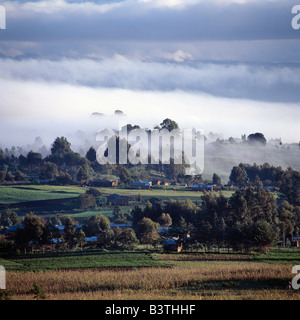 Tanzania, Mbeya. A small market centre near Mbeya is bathed in sunlight as an early morning mist clears from this fertile farming region of Tanzania's Southern Highlands. Stock Photo
