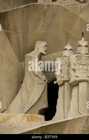 Spain, Barcelona. Gaudi's La Sagrada Familia, Passion Facade detail. Likeness of Gaudi (far left) done by Josep Maria Subirachs. Stock Photo