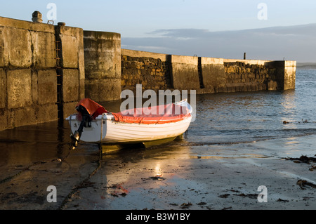 Small motor boat moored at Beadnell Harbour in Northumberland Great Britain Stock Photo