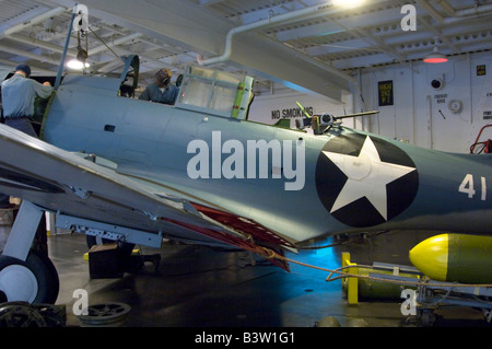 A Douglas SBD-3 Dauntless dive bomber on static 'repair deck' display with mannequins at the Naval Air Museum, NAS Pensacola Stock Photo