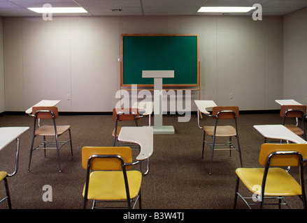 Desks, chairs, podium and blackboard in the classroom of a community college. Stock Photo