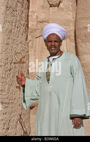 Egyptian in front of temple in Abu Simbel with Ankh Stock Photo