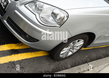 Car parked on double yellow lines no parking line Stock Photo