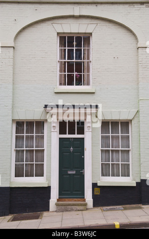 Green front door with white frame and glazed fanlight on townhouse in Ludlow Shropshire England UK Stock Photo