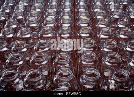 Glass bottles on the assembly line of a glass product manufacturing plant Stock Photo