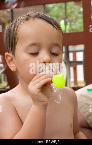 Boy blowing soap bubble Stock Photo