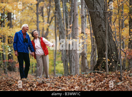 Senior couple hiking in the Autumn woods Stock Photo