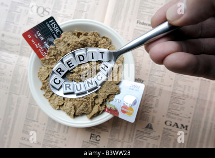 A SPOONFUL OF 'CREDIT CRUNCH' BREAKFAST CEREAL WITH COPY OF FINANCIAL PAPER AND CREDIT CARDS REPRESENTING FINANCIAL CRISIS,UK. Stock Photo