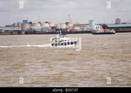 Police boat on the Mersey River with Liverpool behind taking part in the Tall Ships Race and Parade Stock Photo