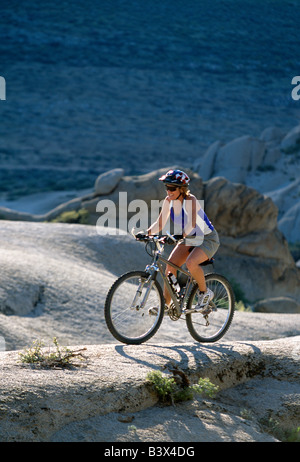 Middle aged woman riding a mountain bike in the Eastern Sierra Mountains in California, USA. Stock Photo