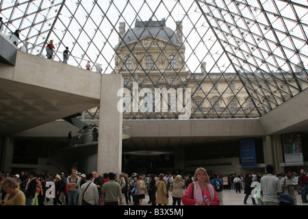 Tourists inside the Louvre Pyramid Paris France Stock Photo