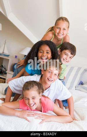 Five Young Friends Lying On Top Of Each Other Stock Photo