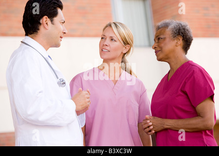 Doctor And Nurses Standing Outside A Hospital Stock Photo