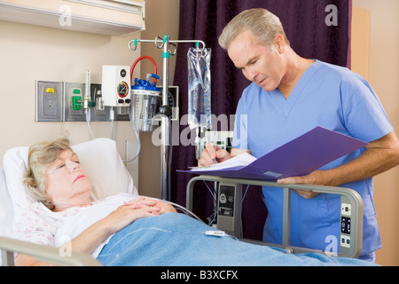 Doctor Making Notes About Patient Stock Photo