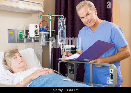 Doctor Making Notes About His Patient Stock Photo