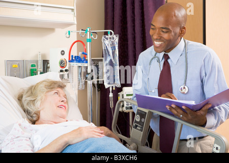 Doctor Making Notes About Patient Stock Photo