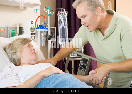 Middle Aged Man Visiting His Mother In Hospital Stock Photo