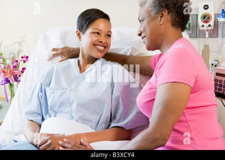 Woman And Her Mother Talking In Hospital Stock Photo