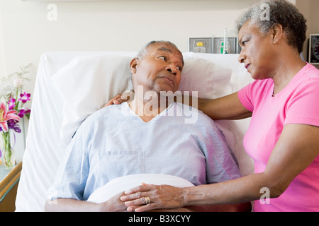 Senior Couple Looking Serious In Hospital Stock Photo