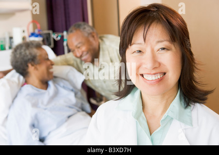 Nurse Smiling In Hospital Room Stock Photo