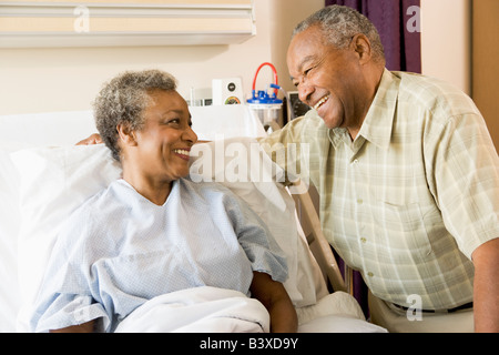 Senior Couple Smiling At Each Other In Hospital Stock Photo