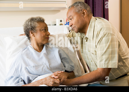 Senior Couple Standing In Hospital Together Stock Photo