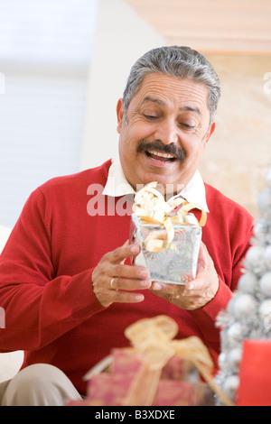 Man Excited To Open Christmas Present Stock Photo
