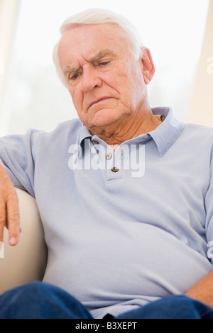 Senior Man Sitting On Couch Stock Photo