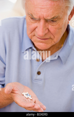Senior Man Looking At Medicine Stock Photo